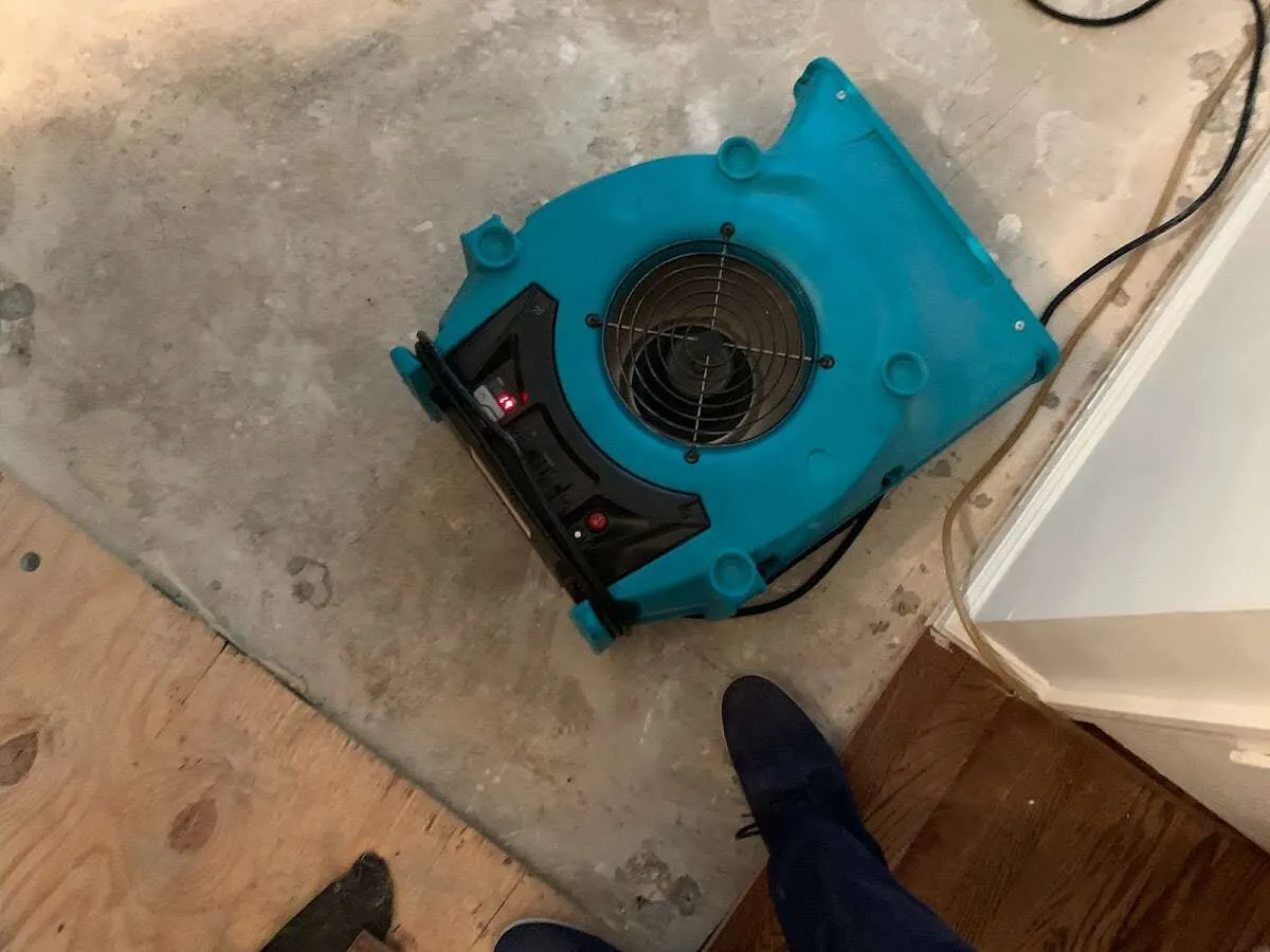 Air mover drying subfloor during Leak Detection & Repair in Manchester-by-the-Sea